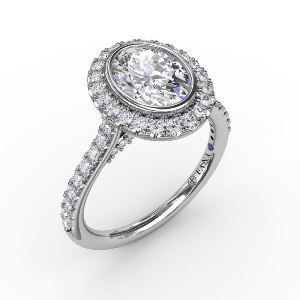 A white gold ring with an oval diamond in the center surrounded by smaller diamonds.