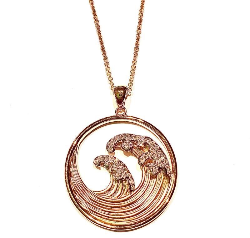 A necklace with a wave shaped pendant on a chain