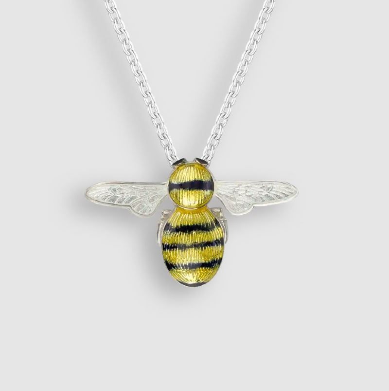 A necklace with a yellow and black bee pendant on a silver chain.