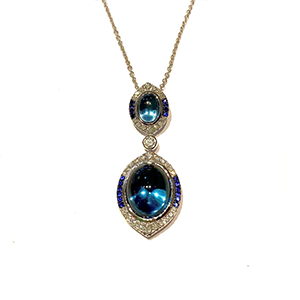 A necklace with two blue stones and diamonds