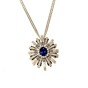 A necklace with a sapphire and diamonds in the center
