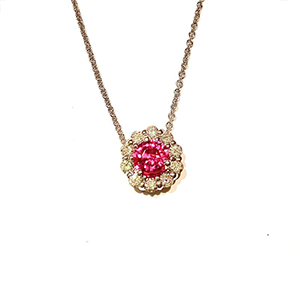 A necklace with a pink stone in the center