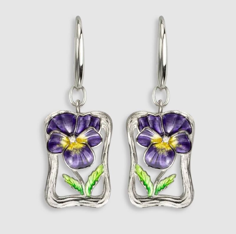 A pair of earrings with purple flowers and green leaves