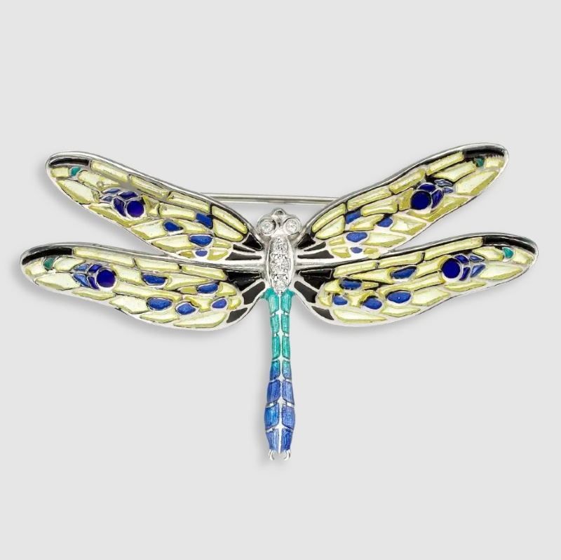 A brooch in the shape of a dragonfly with blue and yellow wings