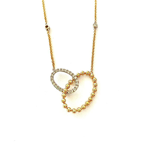 A gold necklace with a heart shaped pendant