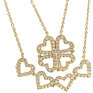Three gold necklaces with hearts and a clover shaped pendant