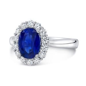 A white gold ring with a sapphire and diamonds