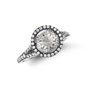 A diamond ring with a round diamond in the center on a white background.