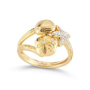 A gold ring with sand dollars and a starfish on it