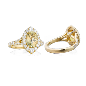 A yellow gold ring with a yellow stone and diamonds