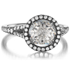 A white gold ring with a round diamond in the center
