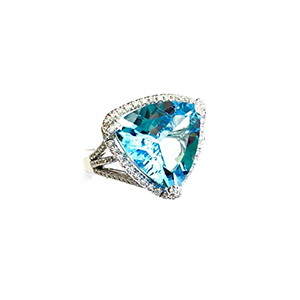 A ring with a blue stone and diamonds on a white background.