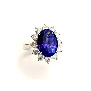 A ring with a sapphire and diamonds on a white background.