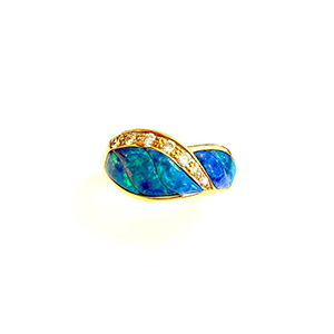 A gold ring with a blue opal and diamonds on a white background.