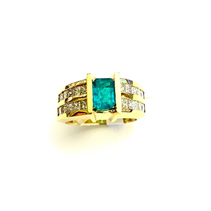 A yellow gold ring with a blue stone and diamonds