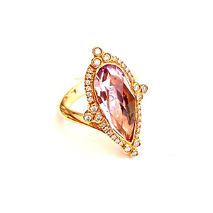 A gold ring with a pink stone and diamonds