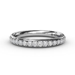 A white gold wedding band with diamonds on a white background.