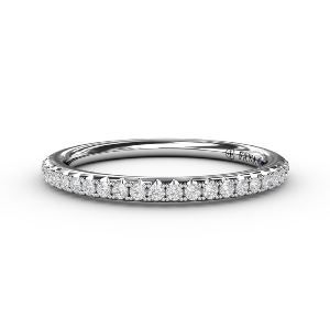 A yellow gold engagement ring with an oval diamond in the center surrounded by smaller diamonds.