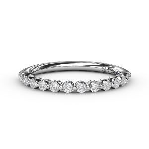 A white gold engagement ring with an oval diamond in the center surrounded by smaller diamonds.