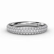 A white gold wedding band with diamonds on a white background.