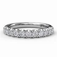 A white gold wedding band with diamonds on a white background.