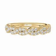 A yellow gold wedding band with diamonds on a white background.