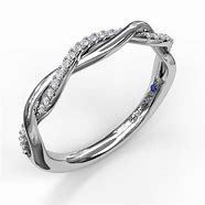 A white gold ring with a twisted design and diamonds on a white background.