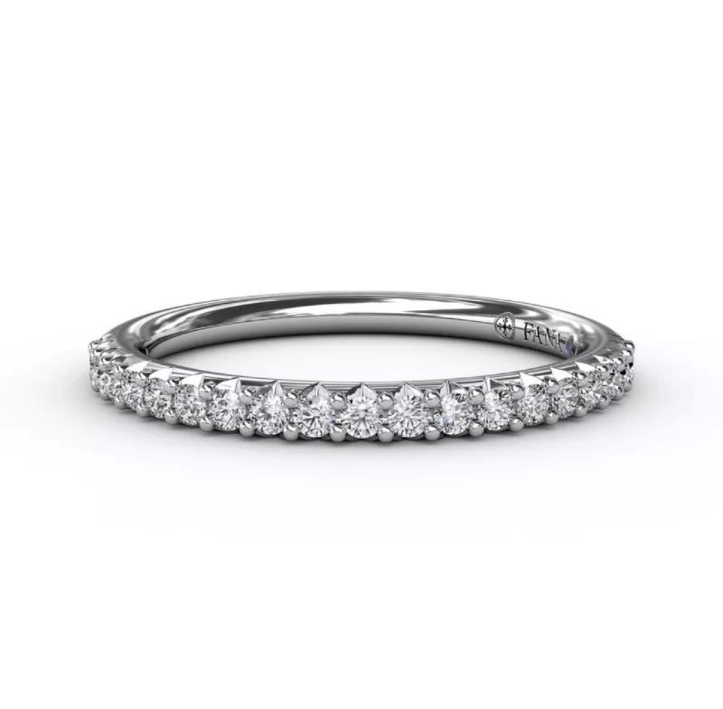 A white gold wedding band with diamonds on a white background.