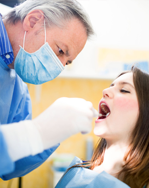 girl having teeth examined