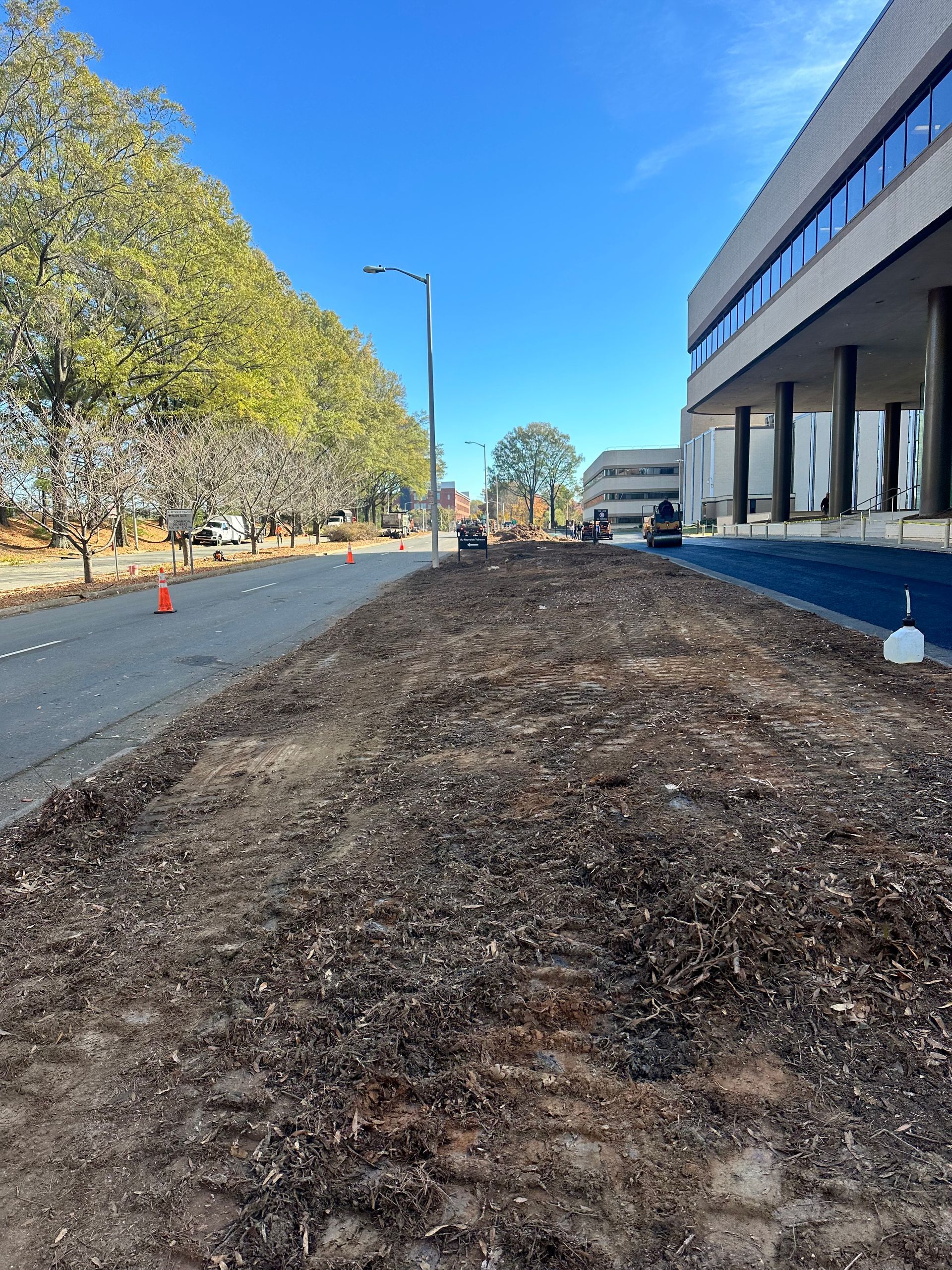 There is a lot of dirt on the side of the road in front of a building.