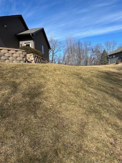 A house is sitting on top of a grassy hill
