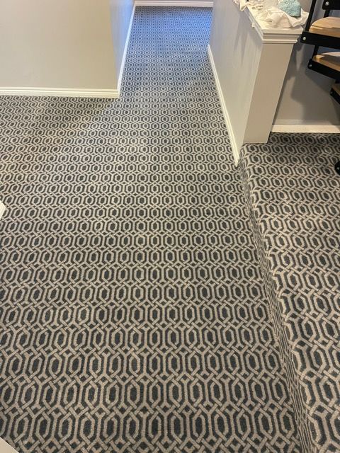 A gray and white tile floor with a geometric pattern