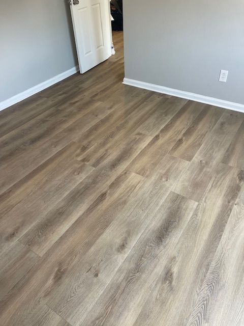 A room with a wooden floor and a door.