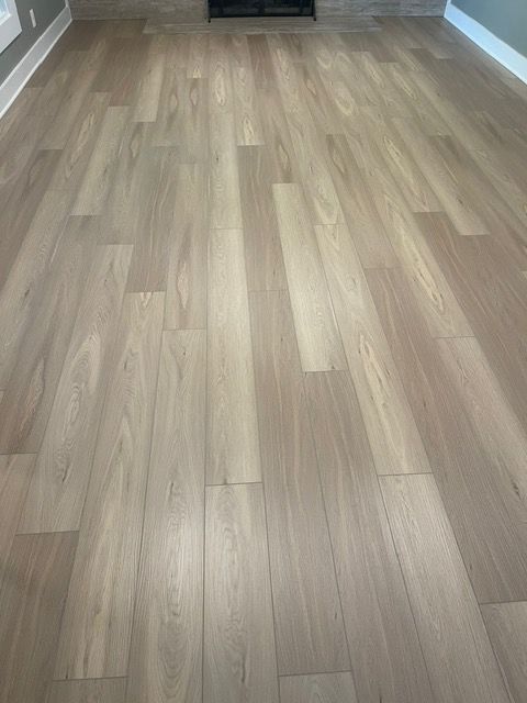 A living room with a hardwood floor and a fireplace.