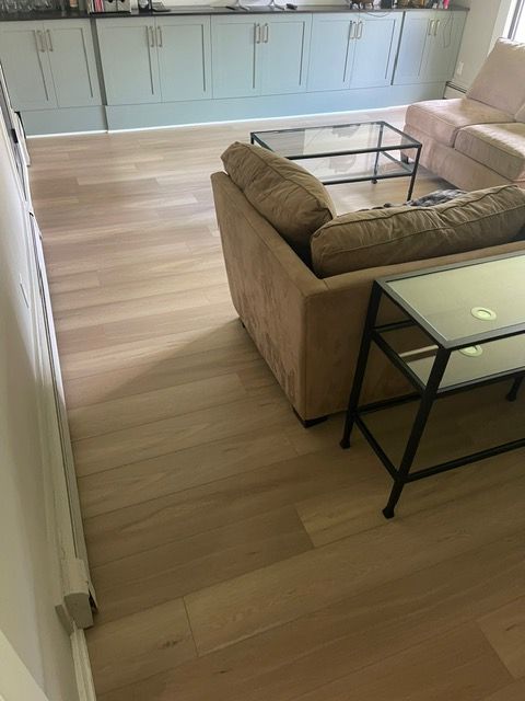 A living room with a couch , chair , and coffee table.