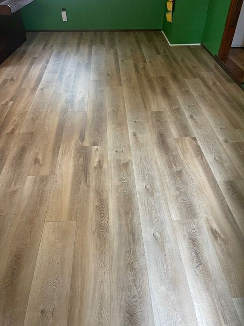 A room with a wooden floor and green walls.