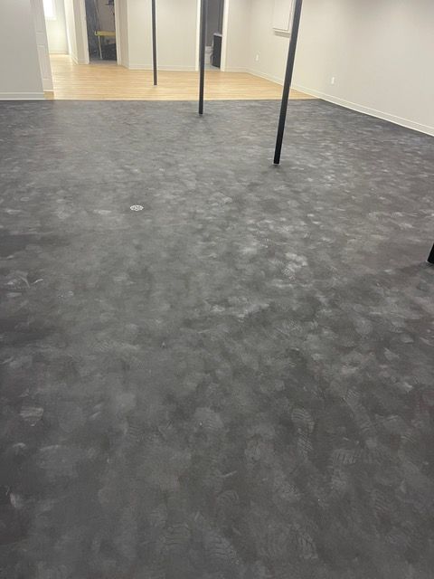 A large room with a gray floor and white walls.