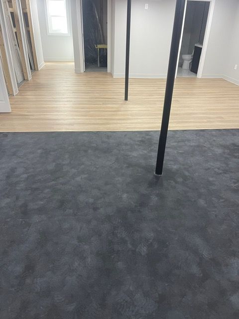 A room with a wooden floor and a black floor