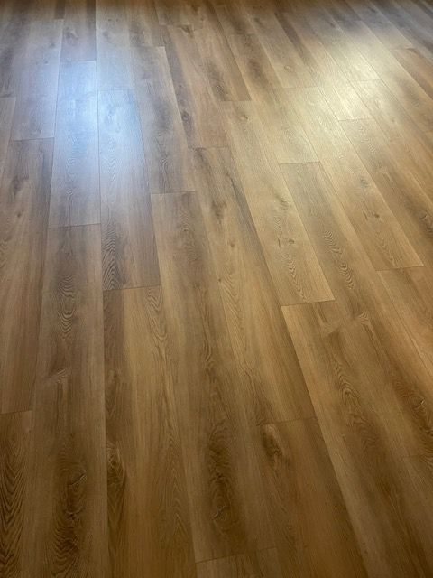 A close up of a wooden floor in a room.