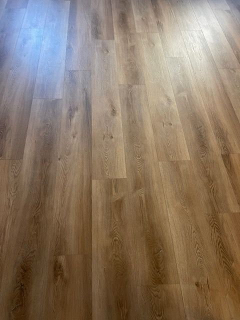 A close up of a wooden floor in a room.