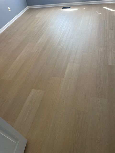 A room with a wooden floor and a door.