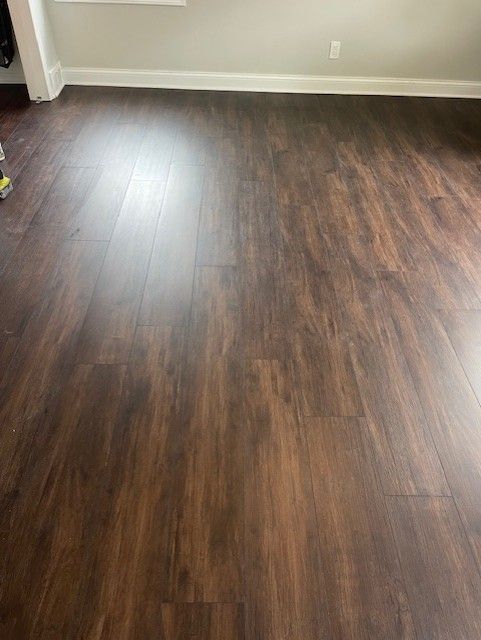 A room with a wooden floor and a window.