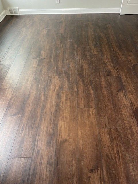 A close up of a wooden floor in a room.