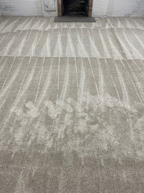A close up of a carpet in a room with a fireplace.