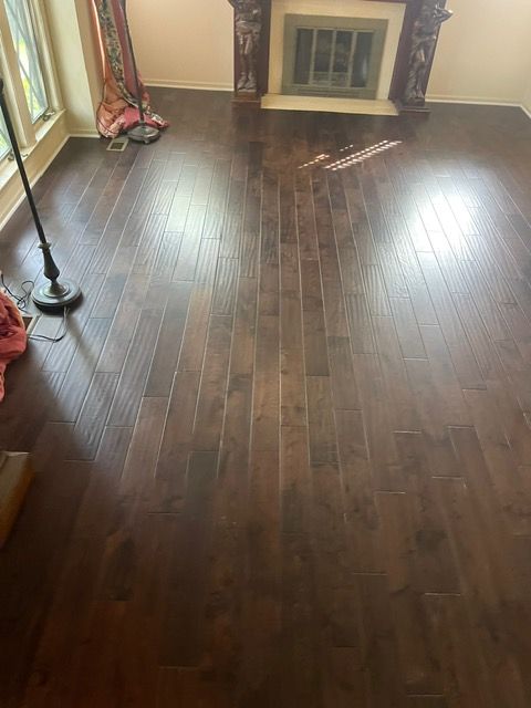 A living room with hardwood floors and a fireplace.