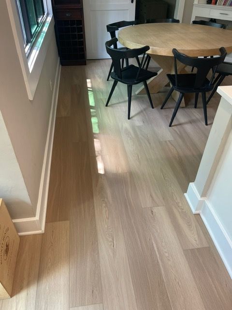 A dining room with a wooden table and chairs