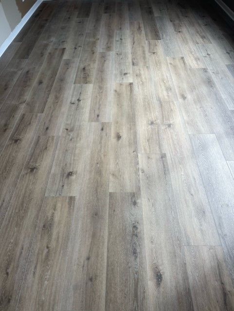 A close up of a wooden floor in a living room.