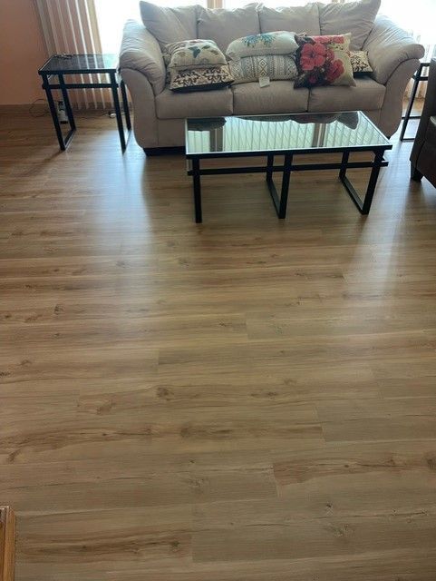 A living room with a couch and two coffee tables.