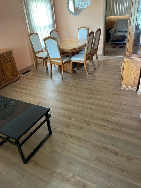 A living room with a table and chairs and a coffee table.