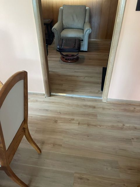 A room with a chair and a table in it